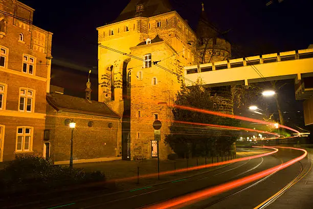 Picture shows a street with a time exposure at night. You see also the light of an driving bus.