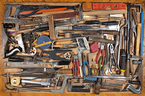 istock Various metalwork and carpentry tools, arranged on a wooden table. 153173207