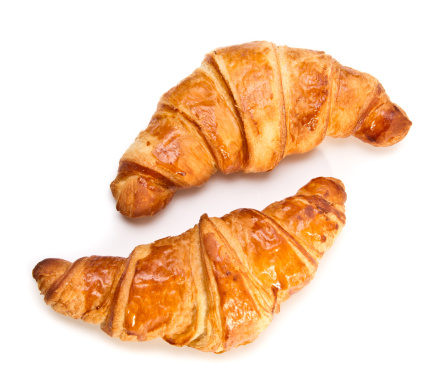 Two French croissants on white background