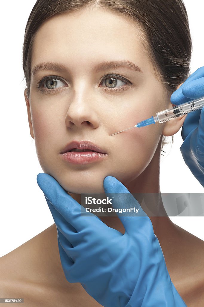 Cosmetic injection of botox Cosmetic injection of botox to the pretty female face. Isolated on white background 20-24 Years Stock Photo