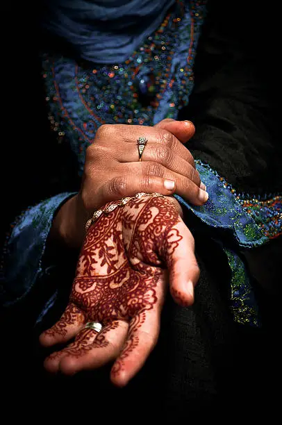 Photo of Mehendi, henna body art on a muslim woman's hand