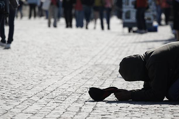 istock Prostrate homeless man begging for money 153175543