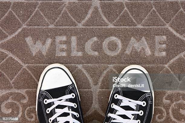 Welcome Mat With Black And White Sneakers Stock Photo - Download Image Now - Domestic Life, Welcome Sign, Greeting