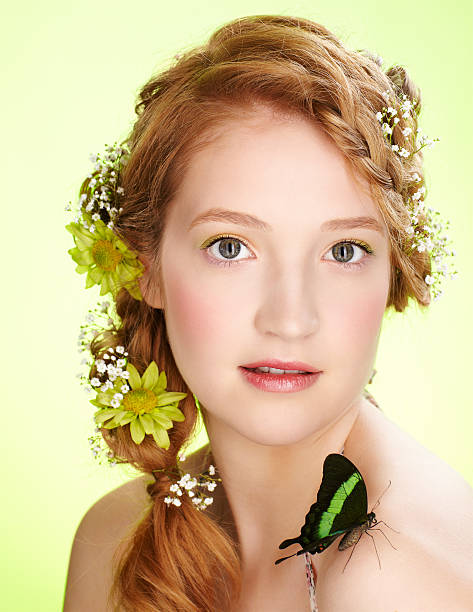 beautiful girl and butterfly portrait of beautiful healthy redhead teen girl with flowers in her hair holding butterfly on her shoulder papilio palinurus stock pictures, royalty-free photos & images