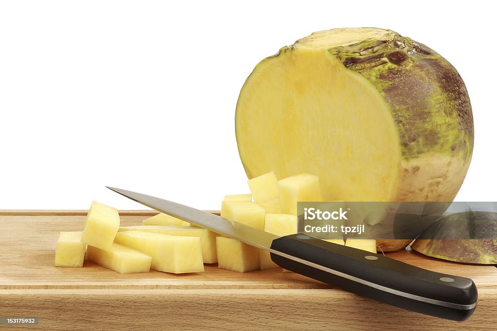 one fresh cut turnip with a kitchen knife one fresh cut turnip(Brassica rapa rapa) with a kitchen knife and cutting board on a white background Rutabaga Stock Photo