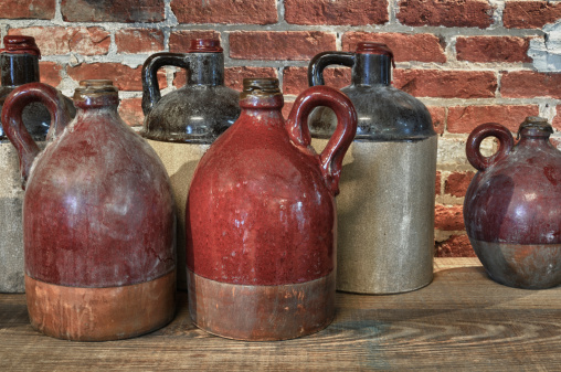 Old jugs on shelf in store.