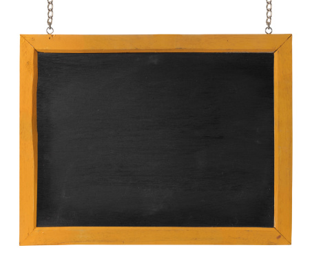 Chalk brush sitting in front of chalkboard.