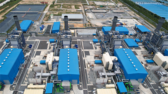 Top view of Electric plants generator from gas and oil send power line to Town, Aerial view of a huge power plant on the industrial estate in Thailand