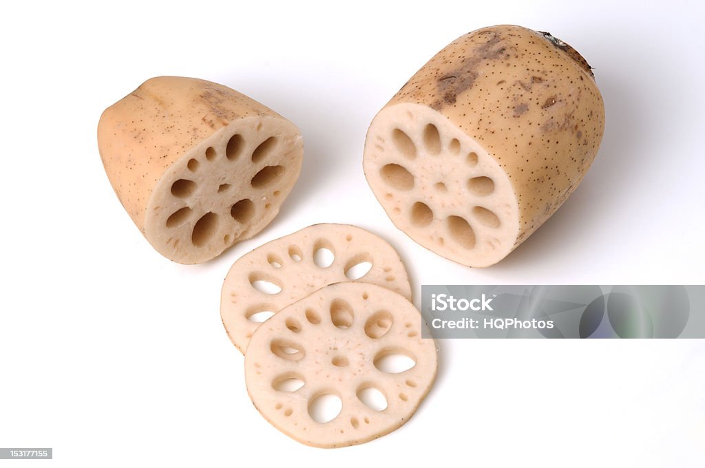 Lotus Root and Slices A lotus root is cut in half, and a few slices are shown. Cross Section Stock Photo