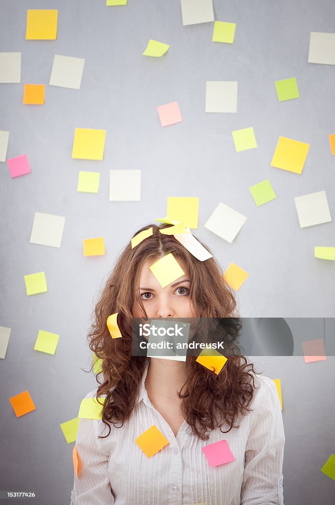secretary with many notes secretary overwhelmed with sticky reminder notes Adult Stock Photo