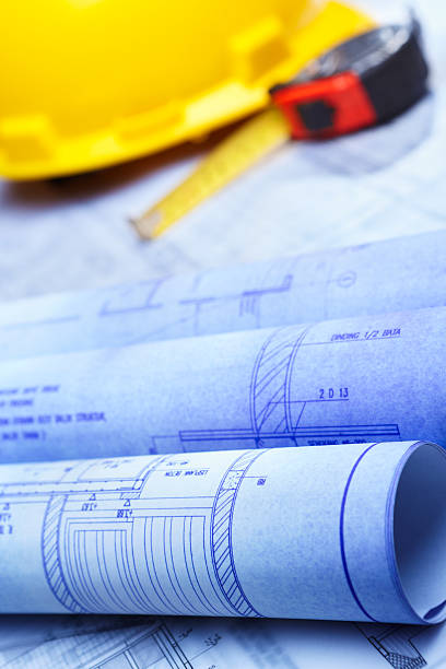 istock Architect design printout and safety helmet 153177497