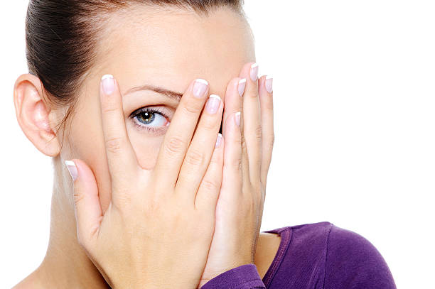 istock woman hide her face and watch through fingers 153177888