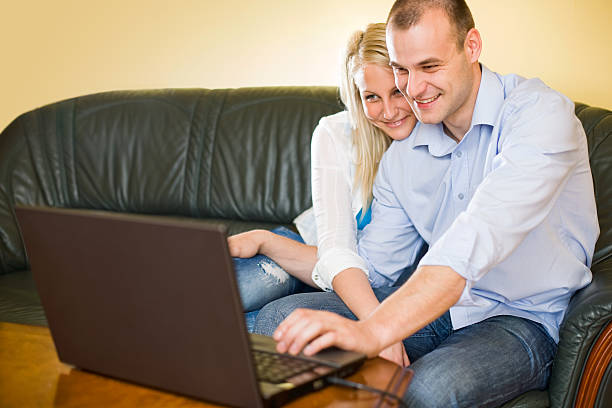 istock Attractive happy young couple having fun with laptop. 153178780