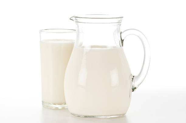 istock Glass and pitcher filled with milk. 153179425