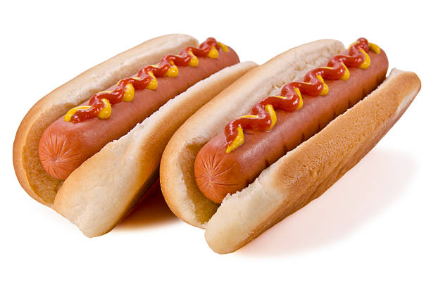 Two hot dogs with ketchup and mustard on top