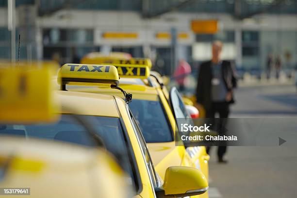A Line Of Taxis And An Out Of Focus Man Stock Photo - Download Image Now - Taxi, Airport, Service