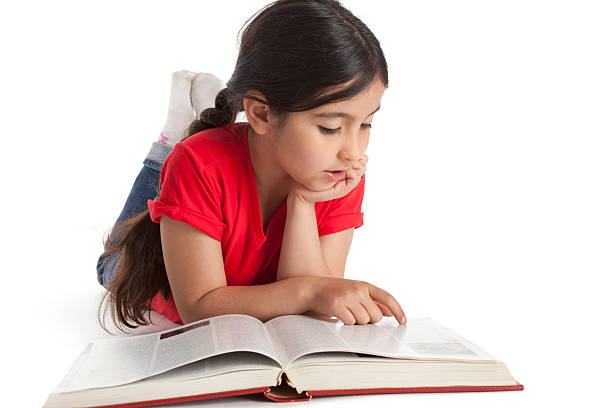 istock Eight year old girl reading a book 153181049