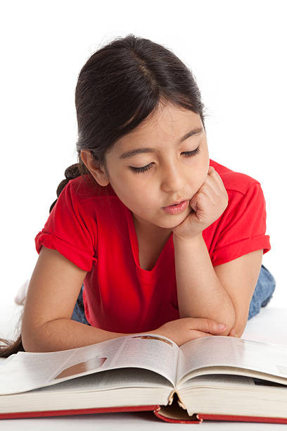istock Eight year old girl reading a book 153181051