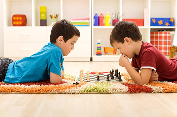 istock Kids playing chess on colorful rug 153181111
