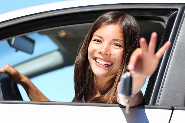 istock Woman driver in car showing keys 153181691