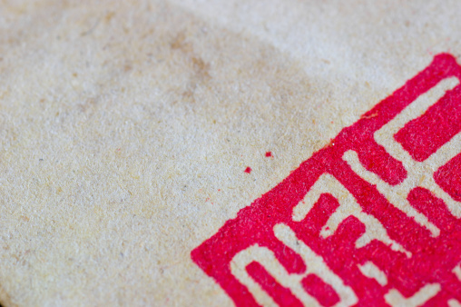 Macro view of vintage oriental paper with red chinese sign
