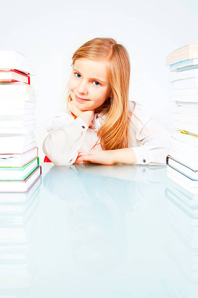 istock smiling girl with books in library 153182147