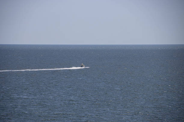 Aerial drone photos of sailboat and speedboat cruising in Øresund, a marine national park in Denmark
