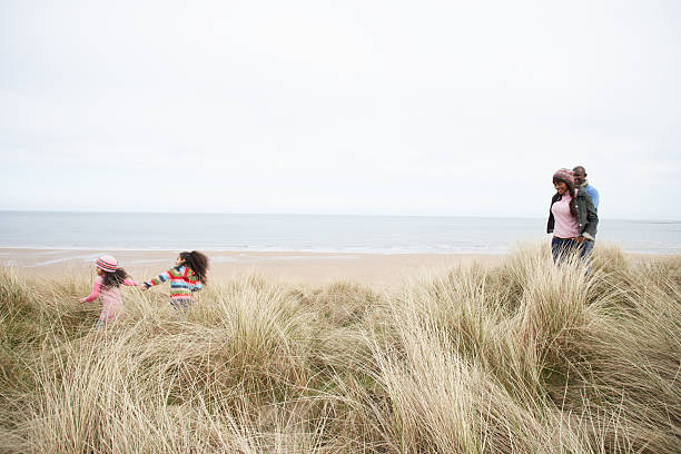 istock Family Walking In Sand Dunes 153185098
