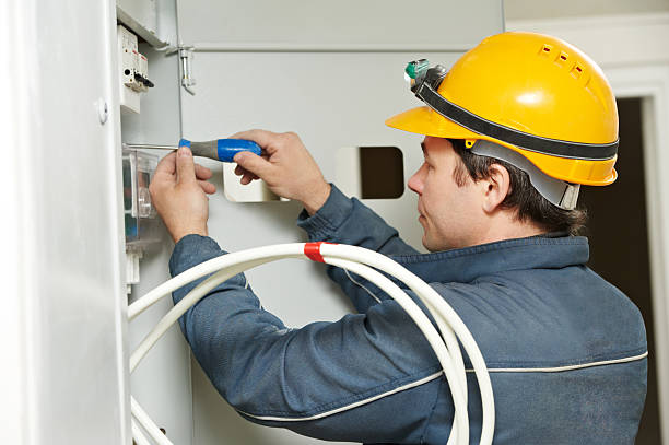 istock An electrician in a yellow hard hat fits a meter 153191484