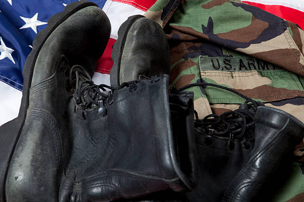 istock Army boots and uniform on US flag 153192328