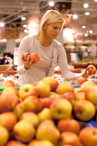 istock women buying apple 153194190