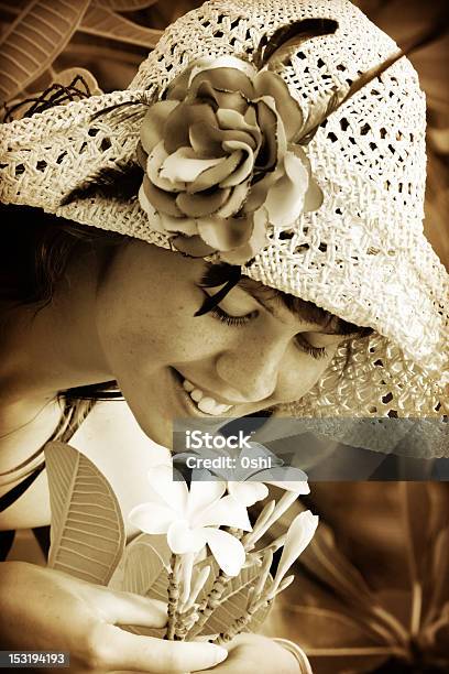 Young Woman Smelling Tropical Flowers Stock Photo - Download Image Now - 20-29 Years, Adult, Adults Only