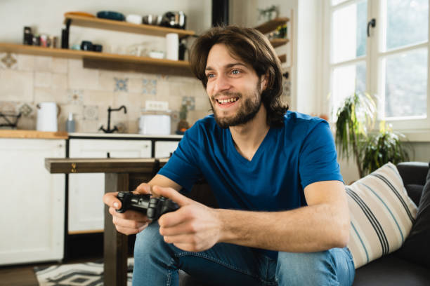 istock Portrait of a young excited man playing video games 1531968107