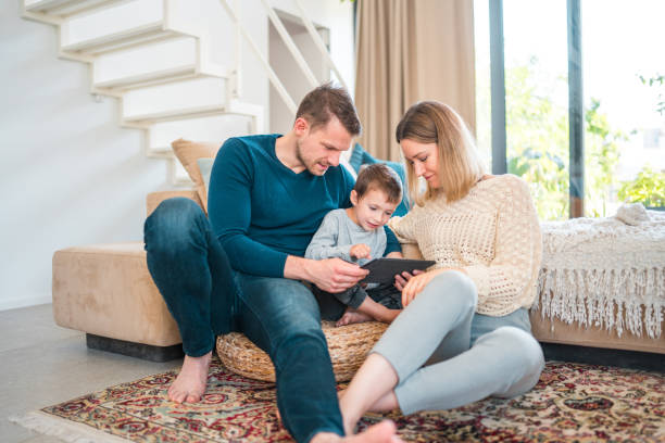 istock Happy Young Boy And His Parents Using A Tablet 1531979507