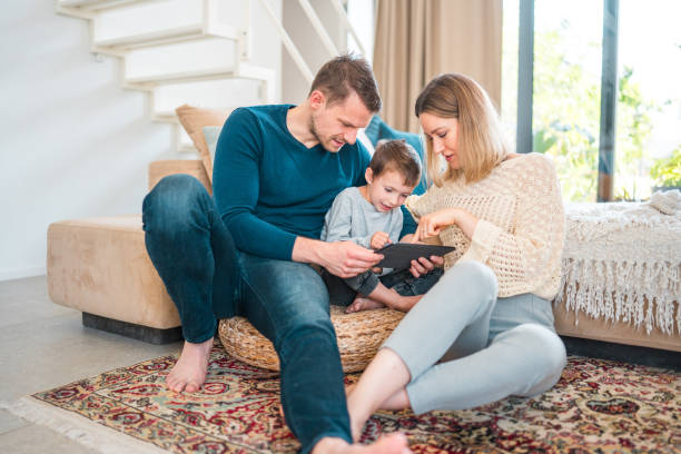 istock Happy Young Boy And His Parents Using A Tablet 1531979508