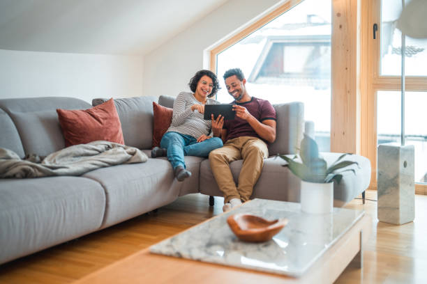 istock Modern Latin American Pregnant Couple Relaxing At Home, Using Wireless Technology 1532001162
