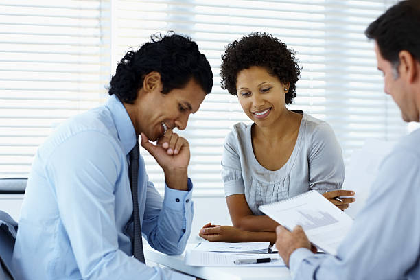istock Business people smiling with documents in a meeting 153200288