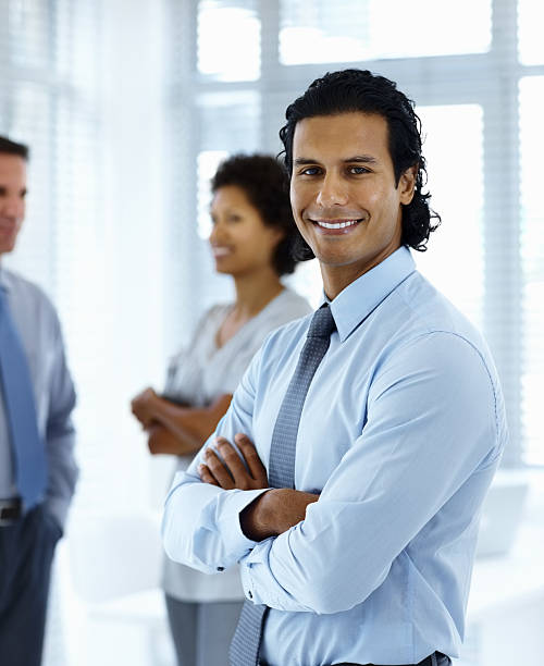 istock Businessman smiling with colleagues standing in the background 153200316