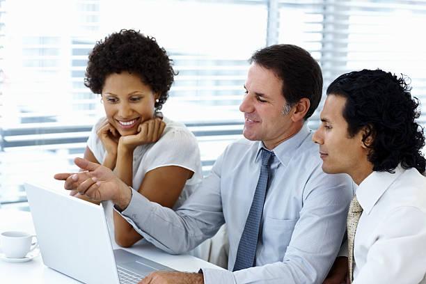istock Group of business people working on a laptop 153200326