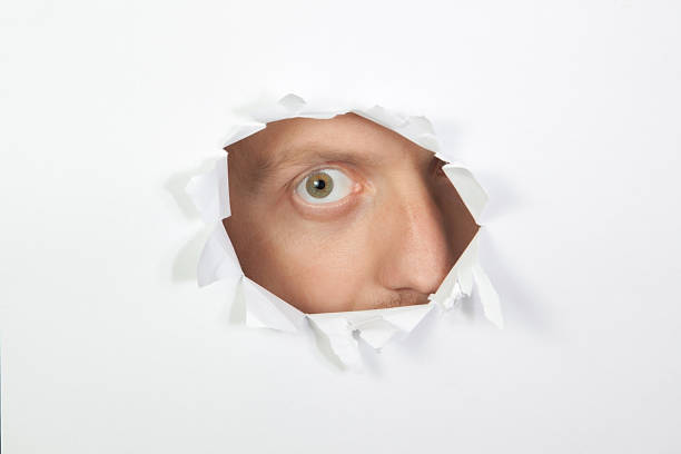 istock Secret look through the hole in paper. 153201319