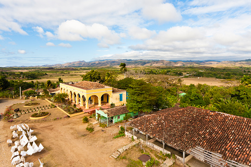 Valle de los Ingenios seen from Manaca Iznaga Tower. Once this was an area covered with plantations of sugar cane, which employed thousands of slaves. The tower from where this photograph was taken was used to monitor the slaves at work. The yellow building was the residence of the owner of the plantation, now a restaurant. Valle de los Ingenios together with the nearby city of Trinidad was declared UNESCO's World Heritage in 1988. Canon EOS 5D