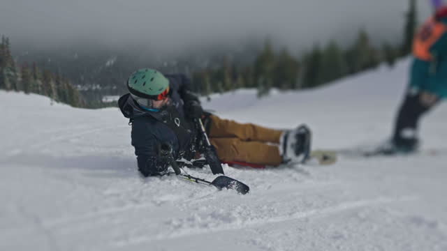Adaptive athlete crashing while learning to sit-ski