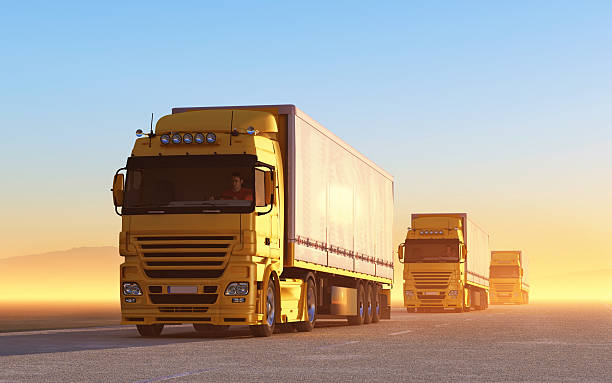 Convoy of yellow trucks on the road convoy of trucks auto shipping stock pictures, royalty-free photos & images