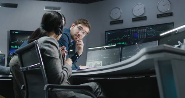 istock Financial analysts monitor and discuss real-time stocks data 1532035073