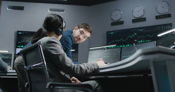 istock Financial analysts monitor and discuss real-time stocks data 1532037125