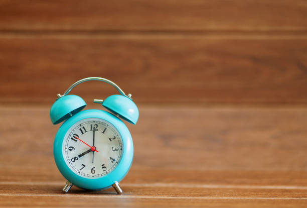 istock Alarm clock on wood background. 1532038153
