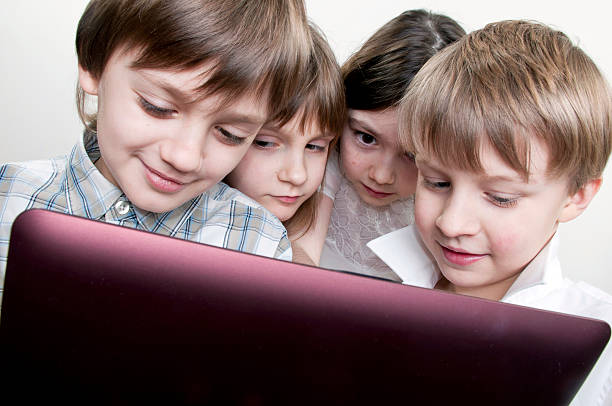 istock group of children friends playing computer games 153203940