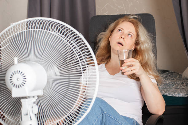 istock Woman using a fan in her home, Heatwave discomfort, Preventing dehydration 1532053392