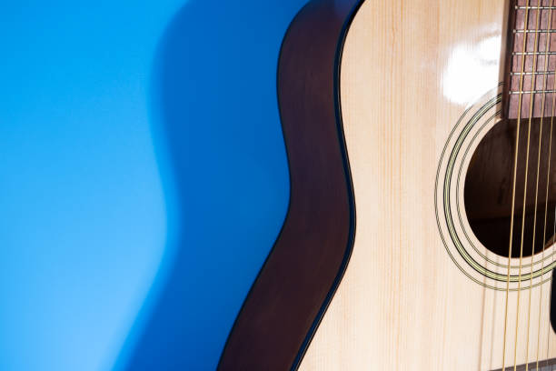 istock wooden guitar on the blue background, copy space 1532054444