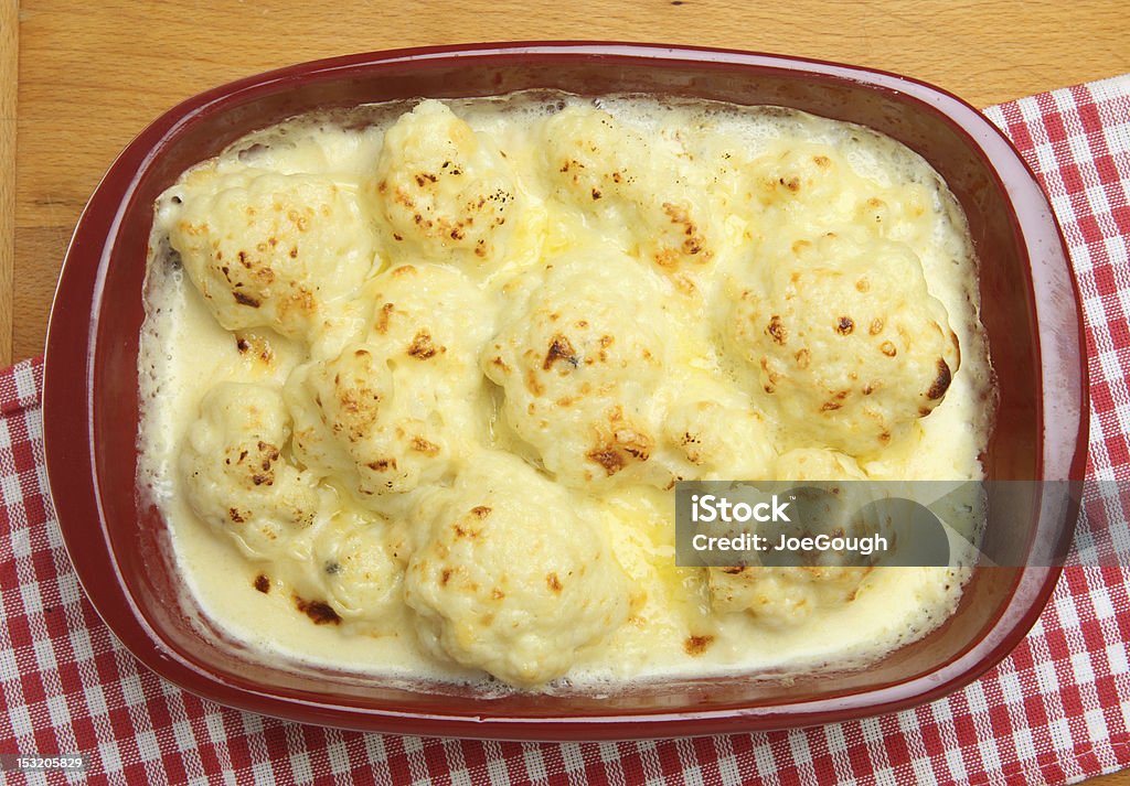 Cauliflower Cheese Freshly baked cauliflower cheese in a ceramic casserole dish. Casserole Dish Stock Photo